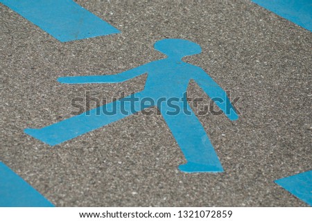 closeup of blue signage for pedestrian in the street 