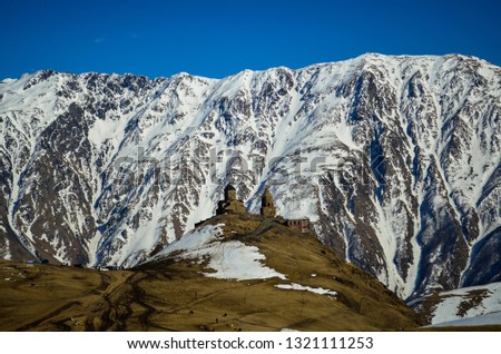 The Trinity Church in Gergeti is located at an altitude of 2,170 m at the foot of Kazbek along the Georgian Military Highway just above the village of Stepantsminda.