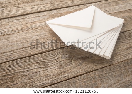 White envelopes on a wood table
