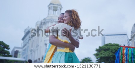 Romance. Couple dancing in the carnival of Brazil with the typical scenario of Recife. Frevo dancing.