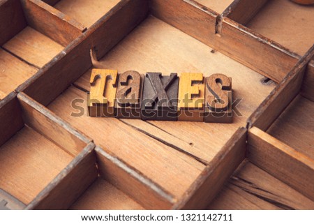 Taxes in wooden typeset letters