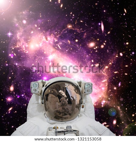 Closeup of astronaut. Galaxy on the background. The elements of this image furnished by NASA.