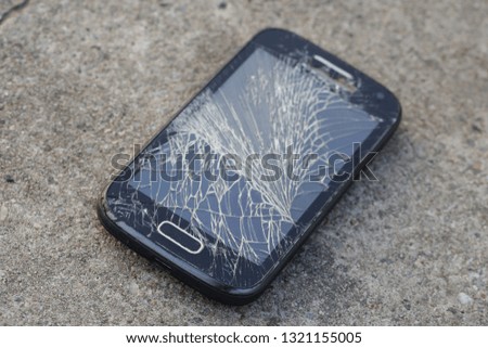 Broken, destroyed, ruined modern mobile smartphone, cell phone, mobile phone, phone. Broken, cracked screen and damages. Device destroyed. Cell phone crashed and scratch. Smash gadget, need repair.