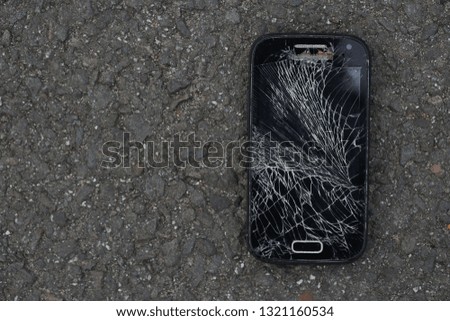 Broken, destroyed, ruined modern mobile smartphone, cell phone, mobile phone, phone. Broken, cracked screen and damages. Device destroyed. Cell phone crashed and scratch. Smash gadget, need repair.