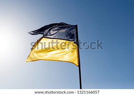 Ukrainian blue yellow flag at sunlight background. flag of european country.