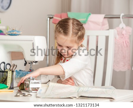 cute little girl in a sewing workshop