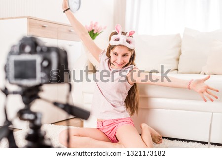 Cute teenaged girl is posing on camera with bunny mask on