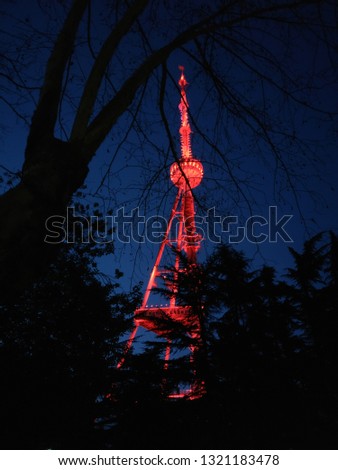 Red neon light TV tower in Tbilisi. Photos of the night city. Lights of the city at night