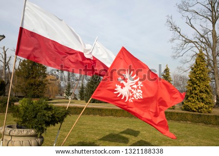 White eagle on red background - flag and emblem of the Greater Poland uprising, polish national colours. Royalty-Free Stock Photo #1321188338