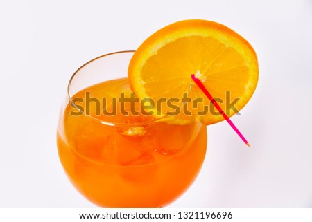 Orange cocktail with orange on the edge of the glass