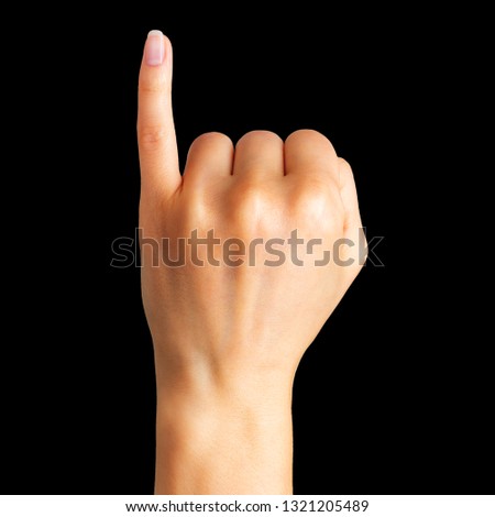 Female hand showing pinky little finger, gesture of making a promise on black background. Isolated with clipping path.