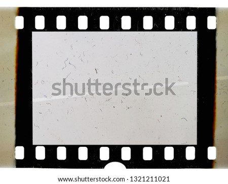 real scan of 35mm movie film strip or photo frame with burned edges, empty retro picture placeholder for your content
