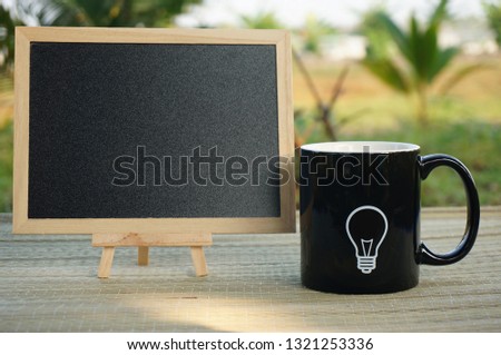 Mug with idea bulb icon with blank blackboard