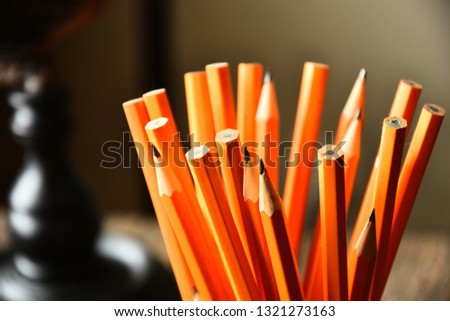 A close up image of several sharpened wooden pencils. 