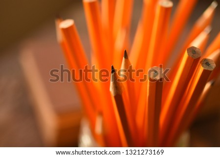 A close up image of several sharpened wooden pencils. 