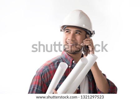 Portrait of asian engineer holding blueprint smiling and using a cellphone isolated on white background