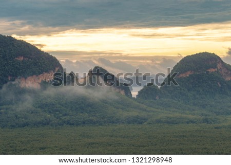 The panoramic background of the surrounding scenery (mountains, sea, islands, clouds, the sky) and the light from the sun in the morning beauty, colorful, is the beauty of nature during travel.