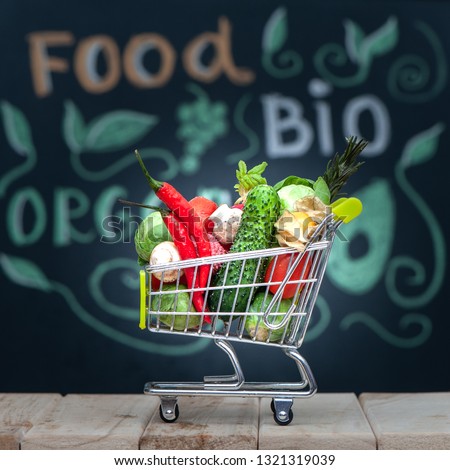 Fitness food.  Theme of nutrition and sports.  Sports nutrition. Healthy lifestyle. Shopping cart  in  full of fruits and vegetables