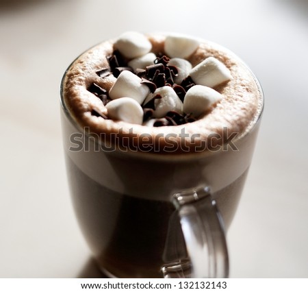 Mug of hot chocolate with marshmallows on table