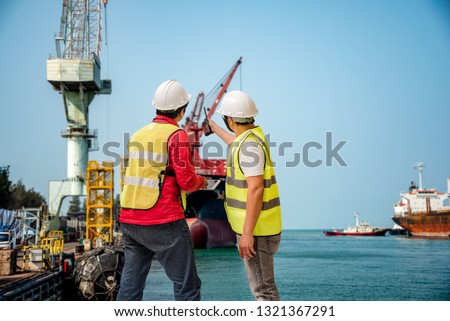 pilot or harbor master, port control in an inspection of the ship in port for operation of export and import the shipment, surveying for safety operation under route regulation issued method Royalty-Free Stock Photo #1321367291