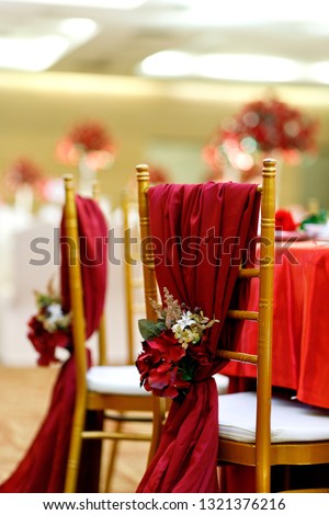 Wedding chairs decorated with flowers in banquet hall