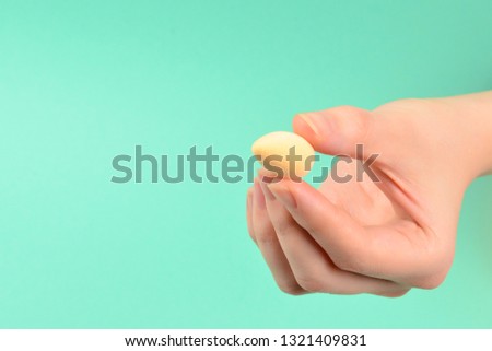 Woman hand holding  beauty sponge  on green background. 