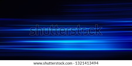 Abstract blue light trails on the dark background Royalty-Free Stock Photo #1321413494