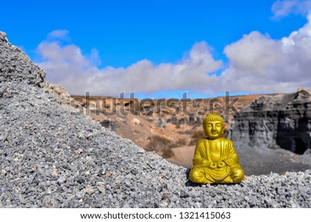 Conceptual Photo Picture of an Buddha in the dry desert