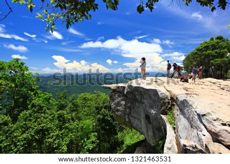 Female photographer standing capture its beauty landscape of Sut Phan Din viewpoint at Pa Hin Ngam National Park in Chaiyaphum Province, Thailand
