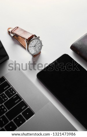 notebook computer with watches on white background. top view copy space