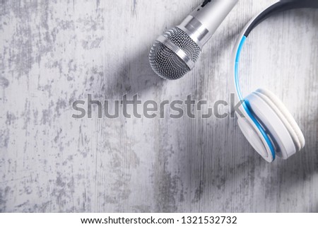 Microphone and headphones on a white desk. Top View