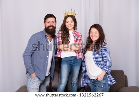Beautiful princess. Little girl love her parents at home. Bearded man and woman with princess daughter. Father, mother and princess child. Family day. Childrens day. Happy family. Royal family.