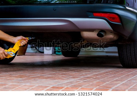 Hands of man holding yellow car towing strap with car. car towing. towing rope