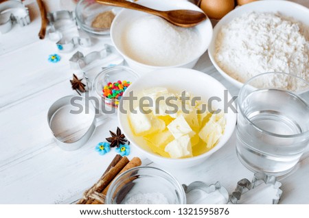 Set of ingredients for cooking festive Easter gingerbread cookies - butter, flour, sugar, eggs, spices with  sugar decor, icing, forms for biscuits, cutting, top view, copy spase. natural light,