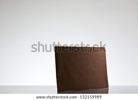 still life image of small parcels wrapped up in brown paper shot on a white background in the studio