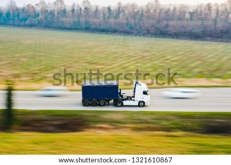 Truck white and blue container in highway delivery your goods buy online on e-commerce. View by Drone - Shipping on the road.