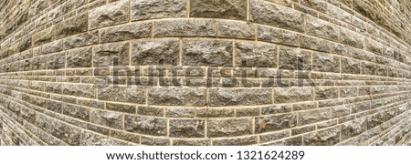 a wall of artistic masonry with a crack