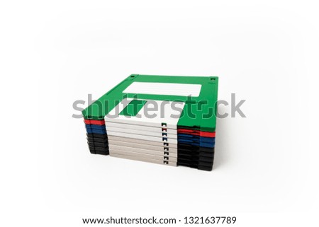 Straight stack of colorful floppy diskettes from side