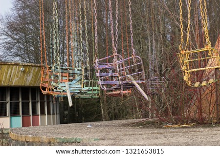 Abandoned amusement park. Not used carousel, swing. Elektrenai, Lithuania Royalty-Free Stock Photo #1321653815