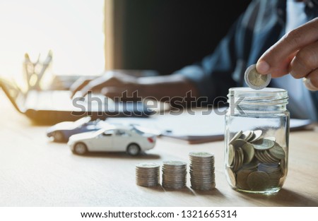 Car insurance and car service with stack of coins. Toy car for accounting and financial concept. Royalty-Free Stock Photo #1321665314