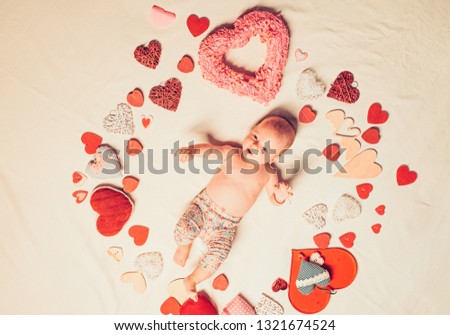Love of my life. Childhood happiness.Valentines day. Sweet little baby. New life and birth. Family. Child care. Small girl among red hearts. Love. Portrait of happy little child.