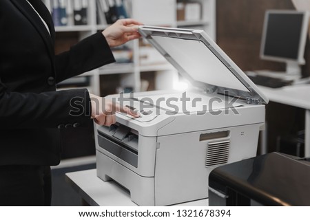 Bussinesswoman hand press button on panel of printer, printer scanner laser office copy machine supplies start concept