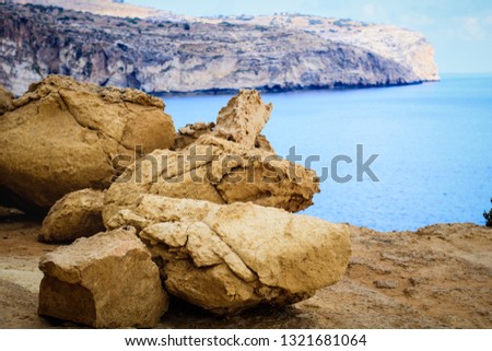 The picture shows the yellow-gold color in the foreground. In the distance you can see a beautiful turquoise blue sea. This photo was taken on the island of Malta