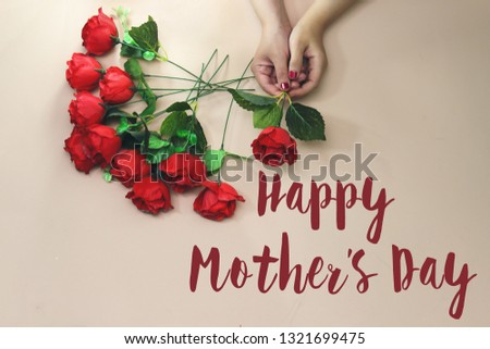 woman hand holding a beautiful rose with happy mother's day concept