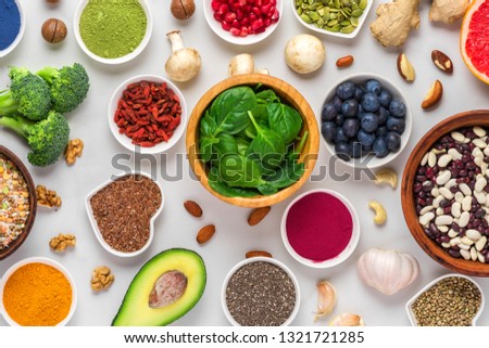 various superfoods on white marble background. vegetables, matcha, acai, turmeric, fruits, berries, avocado, mushrooms, nuts and seeds. healthy vegan food top view Royalty-Free Stock Photo #1321721285