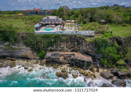 Beach with rocks and hotel with swimming pool, Bali, Indonesia