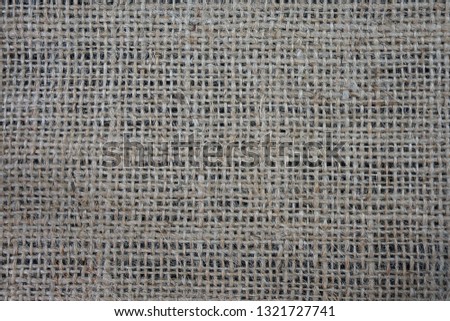 Natural burlap fabric on a black background