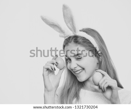 Easter hunt, Woman wink eye in bunny ears with eggs. Happy Easter concept. Holiday celebration, preparation. Festive decoration, symbol, tradition.