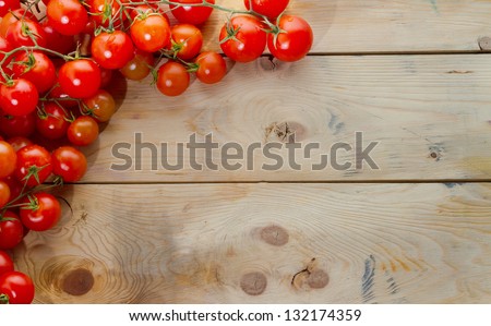 Mediterranean ingredients: ripe tomatoes on rustic wood table. Plenty of copyspace, perfect for a menu. Landscape orientation. Royalty-Free Stock Photo #132174359