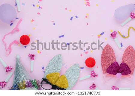 Table top view shot of decorations Happy Easter holiday or carnival party festival background concept.Flat lay bunny ear or mask and objects with confetti on modern rustic pink paper.space for text.